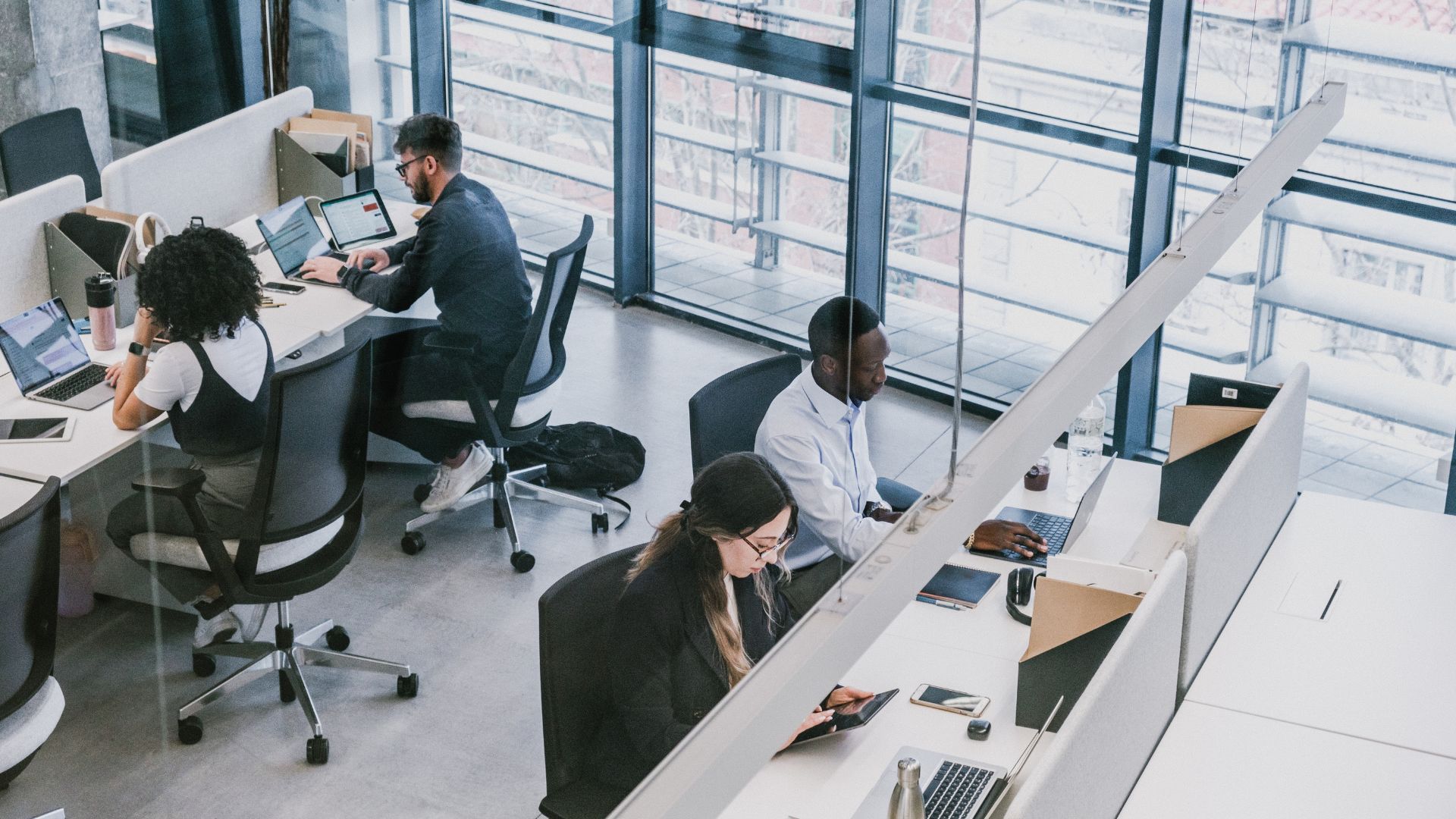 Workers at their desks in an online workspace environment